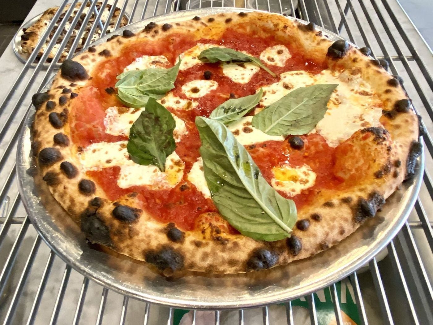 A margarita pizza awaits a takeout box at Pizza Crime in Haddonfield.