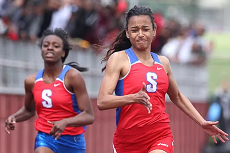 Swenson's Amy Hicks beats out her teammate Imani Harris-Quillen, left, to win the girls' 100-meter run. (Charles Fox/Staff Photographer)