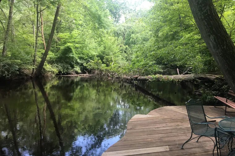 The Rancocas Creek, swollen just two weeks ago due to heavy rainfall in South Jersey, has returned to a lower level. But while water levels are down, recovery efforts are still very much in swing. Featured here is the backyard of Jennifer Roussel on Tuesday July 2. During the storm, she said her home was "an island."