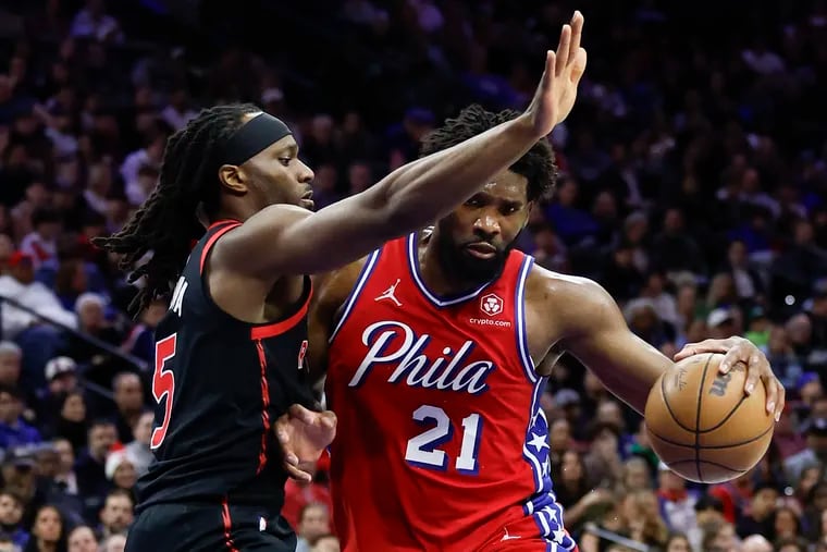 Sixers center Joel Embiid is guarded by Toronto Raptors forward Precious Achiuwa on Dec. 22.