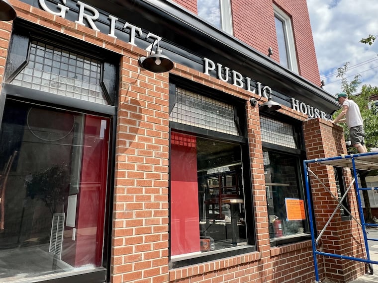 Finishing touches are applied to the facade of Samuel Gritz Public House at Second and Bainbridge Streets on June 14, 2024.