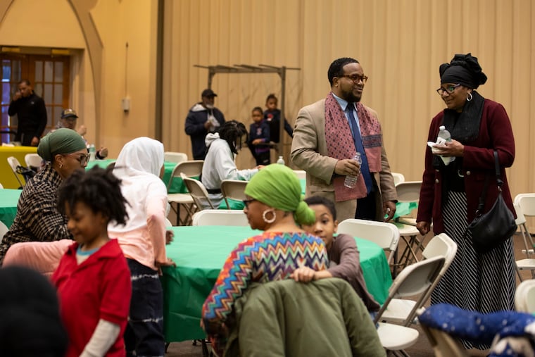 Imam Idris Abdul-Zahir speaks with a member of the mosque Masjidullah in Philadelphia on Tuesday, March 12, 2024. Ramadan is observed by Muslims with a month of fasting. The fast is broken each day with a nightly meal called iftar.