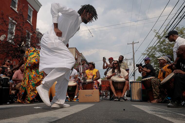 Sheen Anthony of Phila. dances to traditional West African dance music performed by Nubienne Productions at the Odunde Festival on South St. in Phila., Pa. on Sun. June 11, 2023.