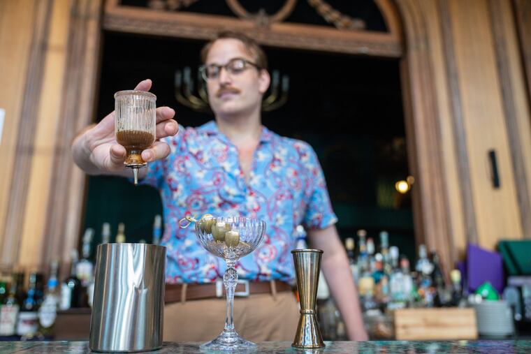 Joshua Scheid, beverage manager, makes a Royal Martini, at Rex at the Royal, in Philadelphia, Wednesday, August 22, 2023.