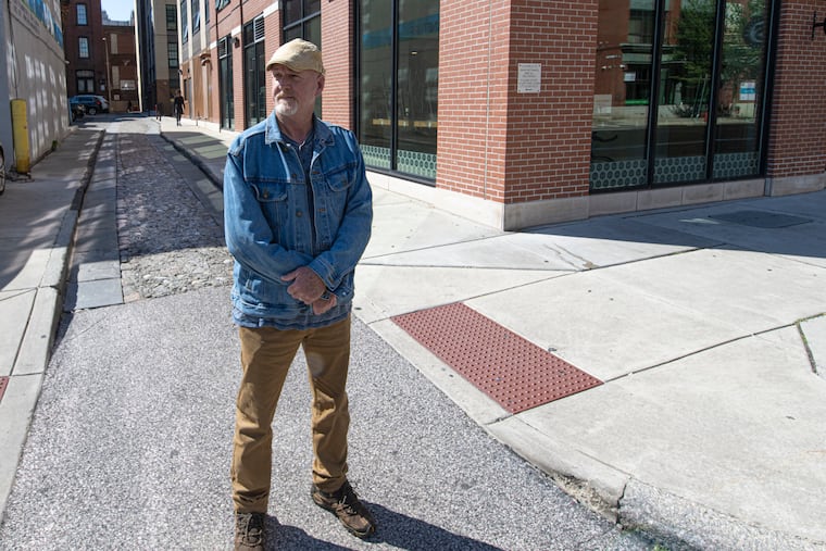 Doug Mooney, president of the Philadelphia Archaeological Forum, is photographed on on Little Boys Court street on 218 Arch St. where he says there are still  people buried beneath the narrow street — probably one of few original cobblestone lanes in the city. 