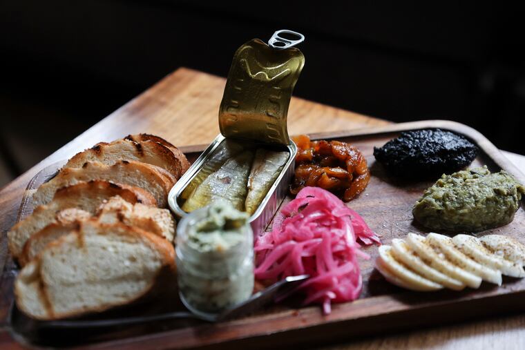 The tinned fish board is photographed at American Sardine Bar at 18th and Federal in the Point Breeze neighborhood of Philadelpia on Thursday, March 7, 2024.