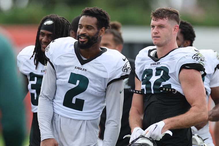 Eagles cornerback Darius Slay (left) and safety Reed Blankenship walk off the field after a training camp session on Aug. 18.