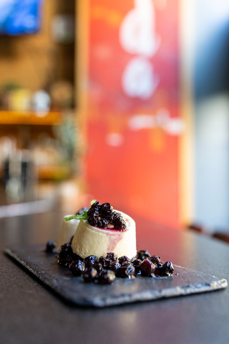 A traditional Indian ice cream (malal kulfi) topped with poached blueberries and creme-de-cassis, at Veda in Philadelphia, Pa., on Thursday, May 25, 2023. 