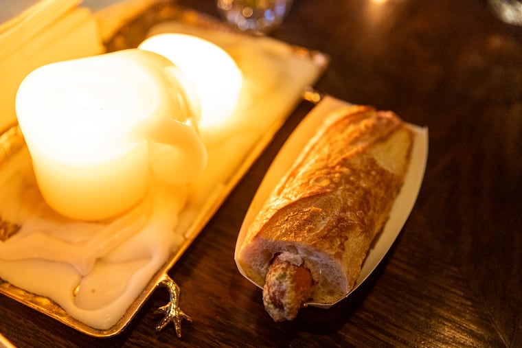 The French hot dog with cornichon butter, dijon and whole grain mustard at Le Caveau, in Philadelphia, Pa., on Friday, August 26, 2022.