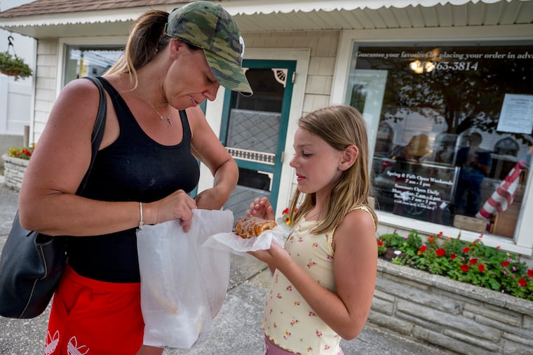 Amy Dunkin and daughter Amy, 9, from Levittown check the donuts and baked goods in their bags at Maryanne Pastry Shoppe in Sea Isle City, Monday, July 24, 2023.