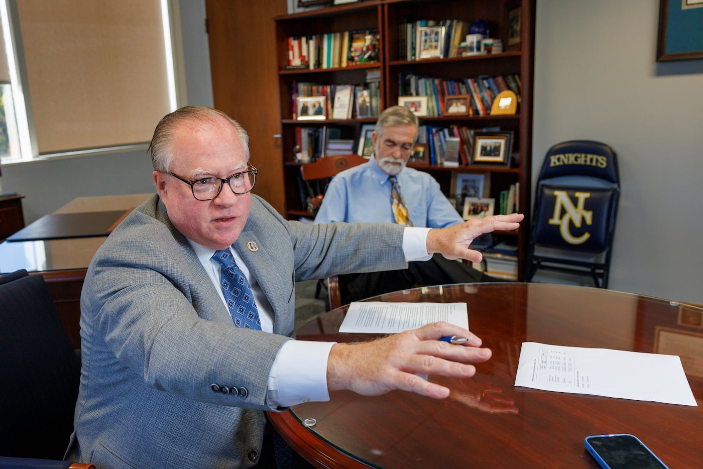 Neumann University President Chris Domes (left) explains his concerns about Gard's index, but acknowledged the school had financial difficulty and made changes to improve. Seated behind him is Steve Bell, director of media relations for the university.