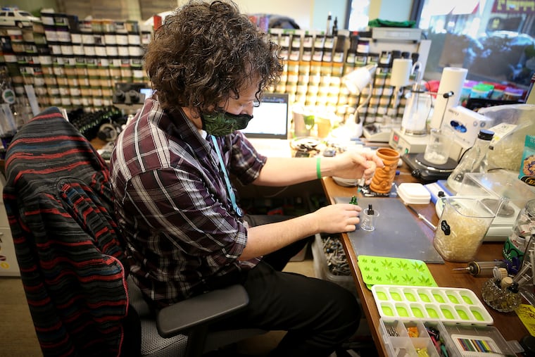 Thomas John Geisel fills a capsule at the TerraVida office in Jenkintown, Pa. on February 8, 2021. TerraVida is medical marijuana dispensary chain.