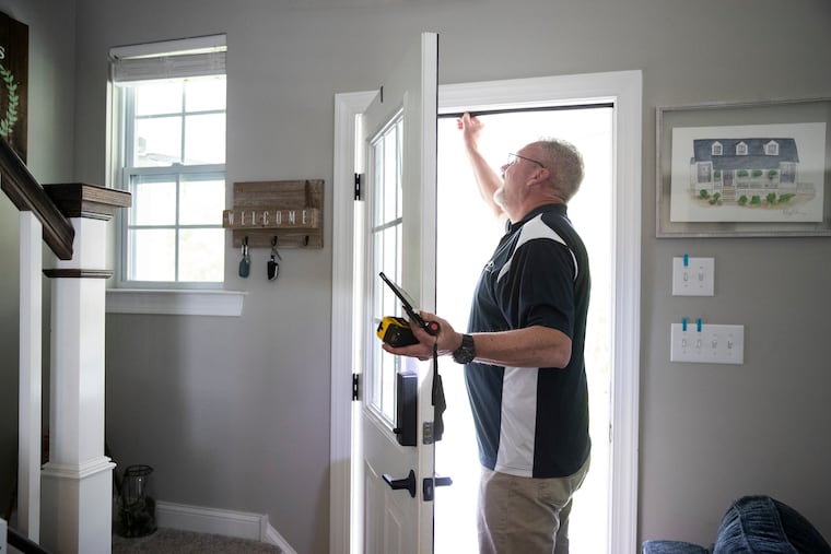 Rich Markoski, a Peco energy assessment's residential field specialist, checks out the door seal at the Smith home in West Chester, Pa., on Thursday, May 4, 2023. Insulating doors and windows is one way to save on your energy bills.