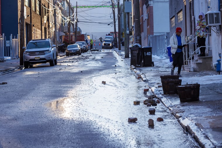 Water Flowing down W. Penn from a main break at corner of W. Penn and Cherry that sent water running down W. Penn Street on a freezing Monday morning in Norristown, PA, Jan. 22, 2024.