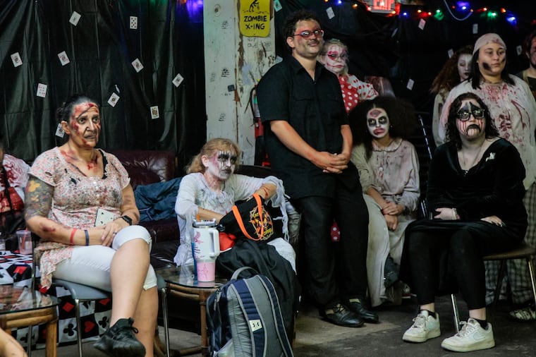 Charmaine Warrington (second from left). a 52-year-old haunter at Fright Factory in South Philly, sits with other actors getting last-minute instructions before the show. Friday October 6, 2023.