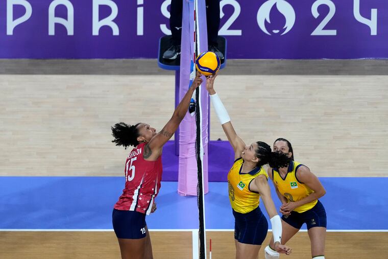 Penn State product Haleigh Washington (left) tries to block a Brazilian attempt during the U.S.' women's volleyball semifinal win.