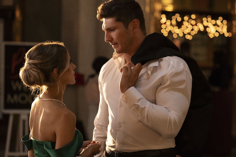 Bowyn Sykes (Jessica Lord) and Drew Gonville (Laith Wallschleger) talk during "Christmas in the Spotlight," a Lifetime movie inspired by Taylor Swift and Travis Kelce, which premiered on Saturday, Nov. 23.