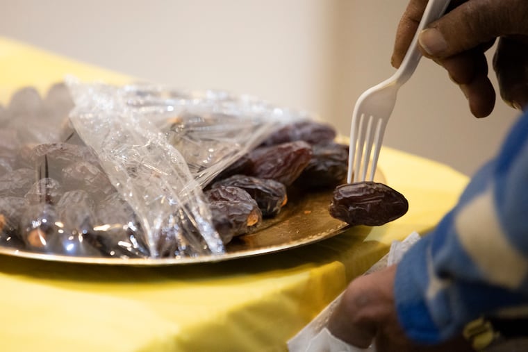 Dates are offered to break the fast at Masjidullah in Philadelphia on Tuesday, March 12, 2024. Ramadan is observed by Muslims with a month of fasting. The fast is broken each day with a nightly meal called iftar.