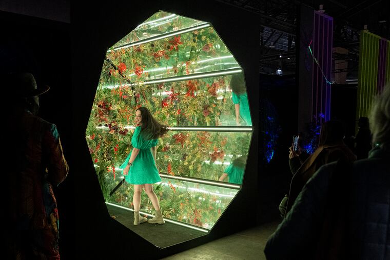 Valeriia Gurtovaia gets her photo taken in a tunnel of flowers at the Flower Show.