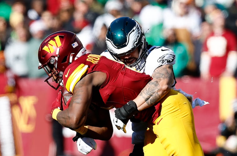 Eagles linebacker Zack Baun stops Washington Commanders running back Brian Robinson Jr. during last month's game.