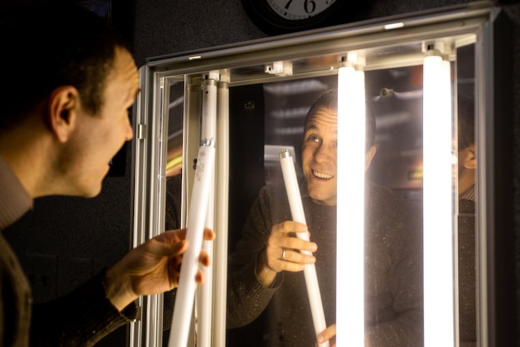 [CAPTION CORRECTION] Jonathan Campbell, assistant manager at Family Video in Warren, PA, changes light bulbs in a movie poster frame Friday, February 1, 2019. Family Video, which opened in 1978 is the first and last standing video rental change in the U.S.