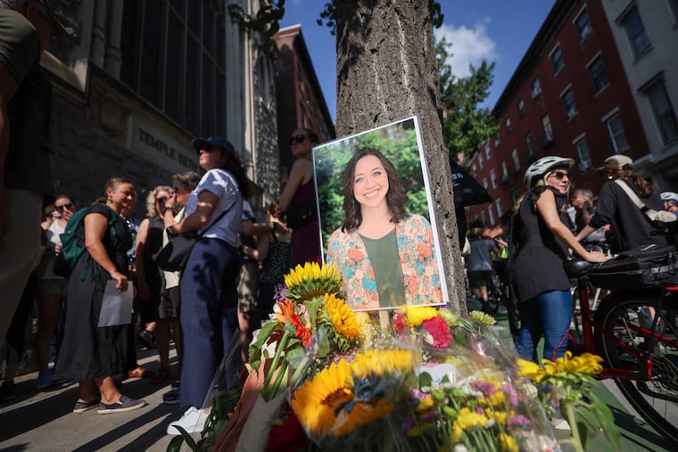 A photo of Barbara Friedes rests against a tree during a vigil on the 1800 block of Spruce Street in Philadelphia, on Sunday, July 21, 2024. Philly Bike Action organized the vigil for Friedes and other cyclists who have been killed. Friedes, a CHOP resident, was killed while biking on Spruce Street earlier in the week.