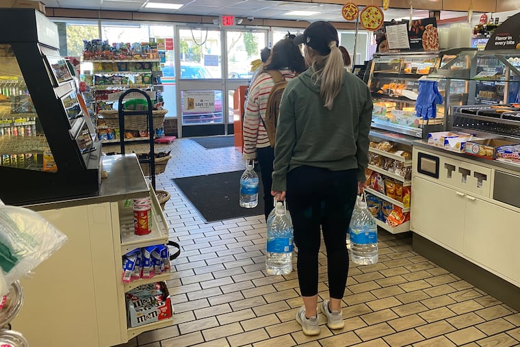 Customers line up to buy water at a 7-11 on Ridge Avenue in Manayunk on Saturday, March 26, 2023. Philadelphia residents were advised to drink bottled water due to a chemical spill in Bucks County.