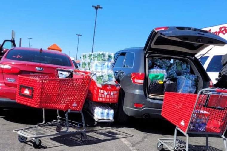 A customer loads water into their vehicle at ShopRite in Port Richmond on Sunday, March 26, 2023. Philadelphia residents were advised to drink bottled water due to a chemical spill in Bucks County.