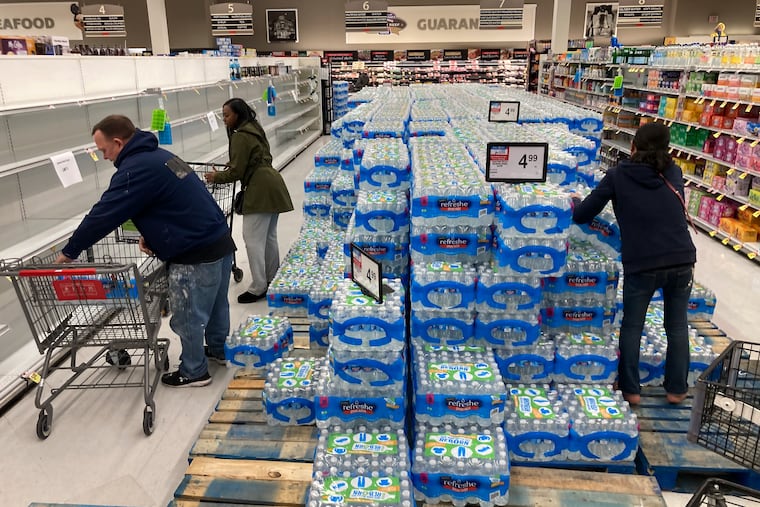 Shoppers stock up on bottled water following a chemical spill into the Delaware River upstream from Philadelphia, Tuesday, March 28, 2023. Health officials in Bucks County, just north of Philadelphia, said Sunday that thousands of gallons of a water-based latex finishing solution spilled into the river late Friday due to a leak at the Trinseo Altuglas chemical facility in Bristol Township. (AP Photo/Matt Rourke)