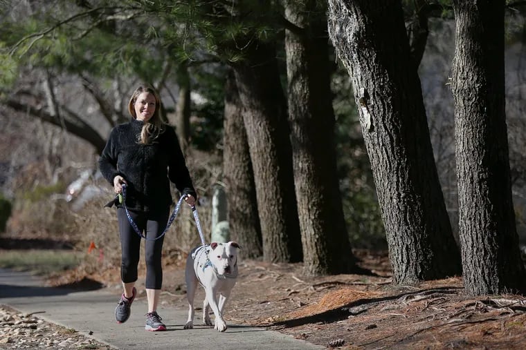Ashley Greenblatt walks with her dog, Lincoln, near her home in Voorhees, N.J. Walking is the most convenient workout since it’s free and requires no equipment. If you’re walking for weight loss, keep it brisk and challenging by incorporating inclines. Aim for 30 minutes, five times a week.