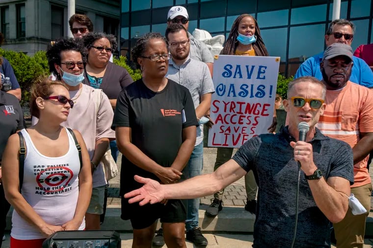 Political activist Jay Lassiter (with microphone), a former intravenous drug user, speaks at a protest against the closing of the Oasis Drop in Center needle exchange in Atlantic City in July.
