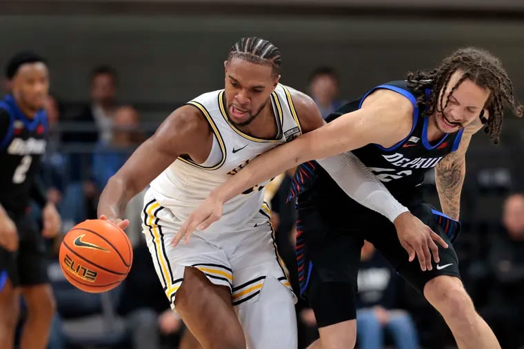 Mac Etienne (right) seen here battling with Villanova's Eric Dixon last season, will do so again as a member of La Salle’s squad this season.