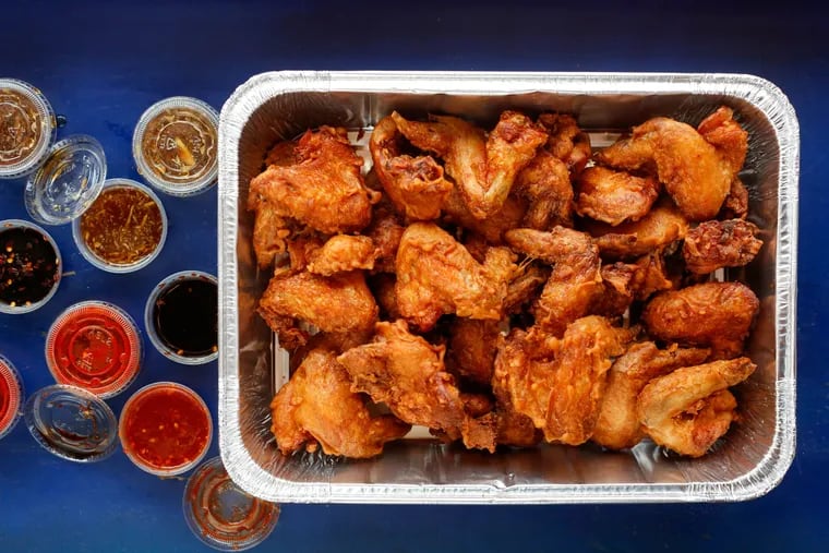 Federal Donuts' wings, served by the tray and in five-piece orders, come glazed in sauce or dry-rubbed with seasonings.