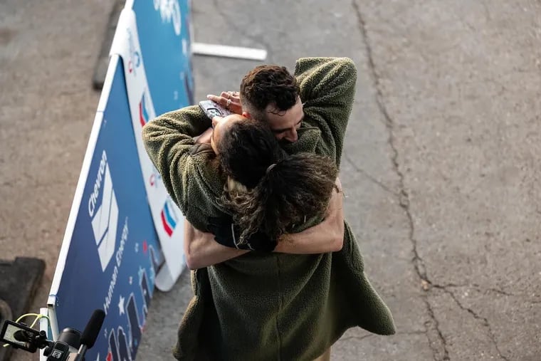 Patrick Tiernan embraces his wife after finishing the Houston Marathon in January, qualifying for the Paris Olympic Games.