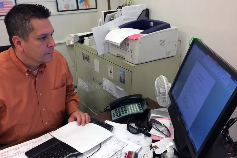 Scott Brown, Veterans Advisory Commission director, reviews plans for the city’s first Veterans Parade from his City Hall office.