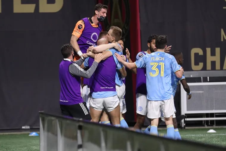 Kacper Przybylko is swarmed by teammates after scoring his second goal against Atlanta.