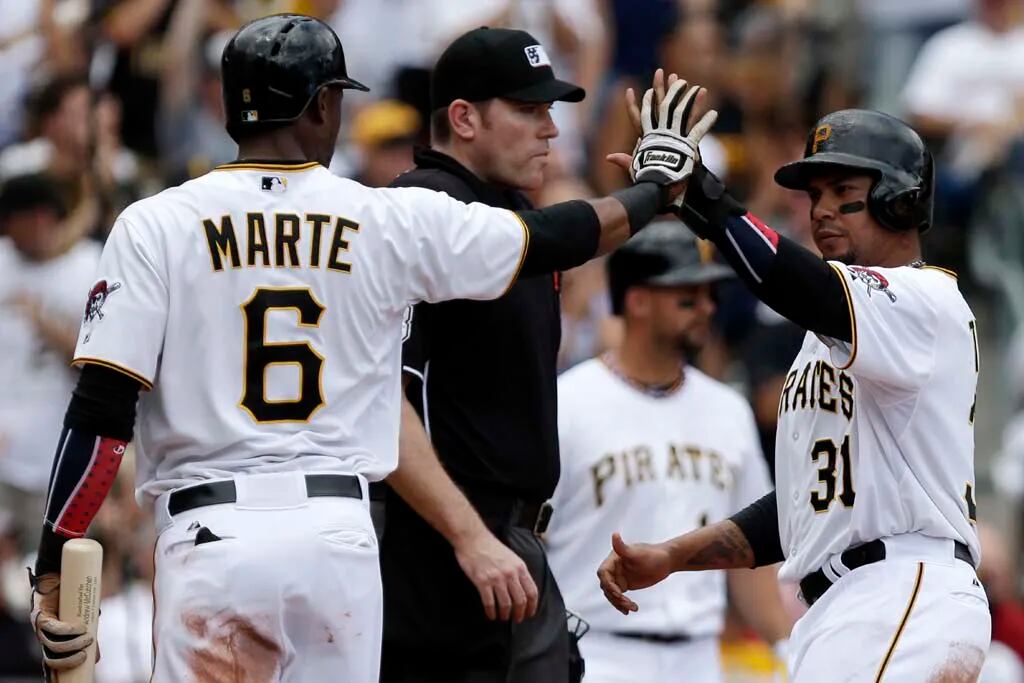 Pittsburgh Pirates' Starling Marte, right, celebrates with Cole