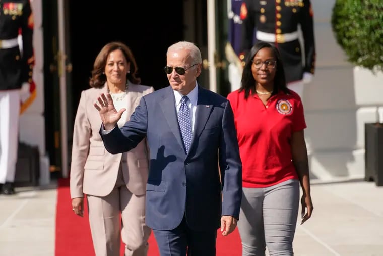 President Joe Biden waves as he arrives with Vice President Kamala Harris and Lovette Jacobs, a fifth-year IBEW Local 103 electrical apprentice in Boston, during a ceremony about the Inflation Reduction Act of 2022, on the South Lawn of the White House in Washington in September.