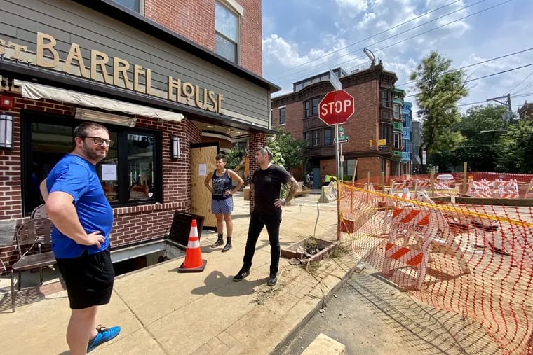 Chivonn Anderson and her business partner, Adam Volk (right), chat with fellow restaurateur Peter Woolsey (left) outside their future restaurant, Redcrest Kitchen, at Sixth and Bainbridge Streets in Philadelphia on Monday. Woolsey owns Bistrot La Minette next door.