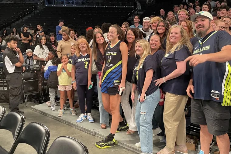 Maddy Siegrist (center) poses for a photo with friends and family after playing for the Dallas Wings against the New York Liberty in her first game back after missing two months due to a broken finger.