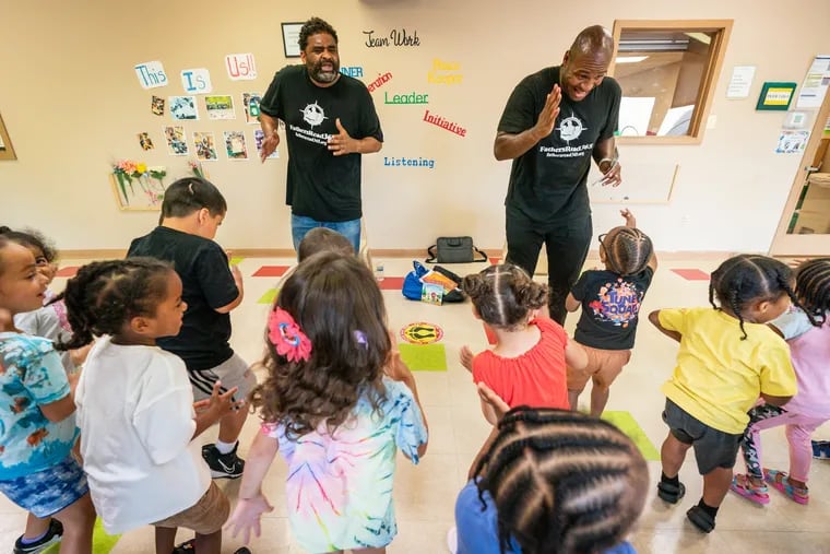 Brent Johnstone, left, and Akeiff Staples, right, co-founders of FathersRead365, talked to the preschoolers at Acelero Learning Center, in Philadelphia, Thursday, July 27, 2023.