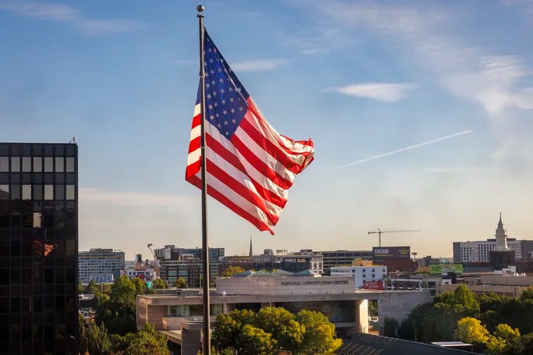 Flag of the United States flying over Federal Building at 6th and Market Street with National Constitution Center in background, Monday, September 9, 2024. Former President Donald Trump and Vice President Kamala Harris will debate at the Constitution Center Tuesday.