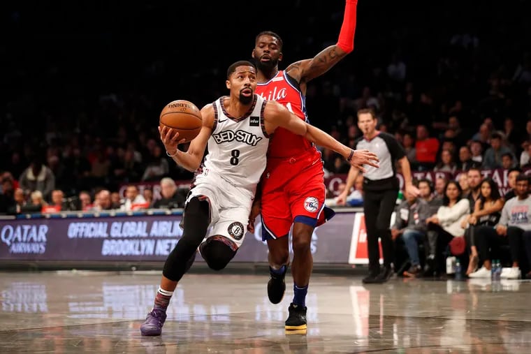 Brooklyn Nets guard Spencer Dinwiddie (8) drives against Philadelphia 76ers forward James Ennis III during the second quarter.