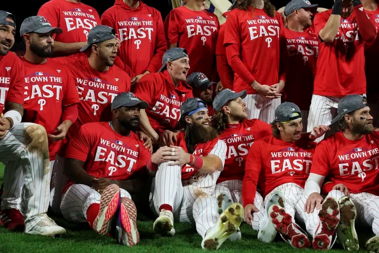 Phillies players pose for a team photo after beating the Cubs on Monday night to win the NL East.