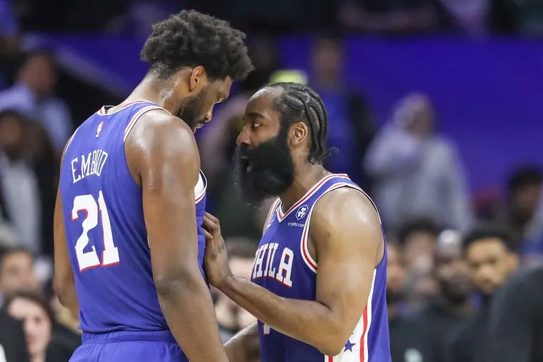 James Harden speaks to teammate Joel Embiid in a game against the Boston Celtics this season. He has made Embiid better.