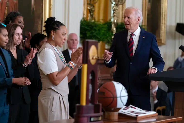 Dawn Staley applauds as President Joe Biden speaks at a reception honoring the South Carolina women's basketball team's national championship on Tuesday.