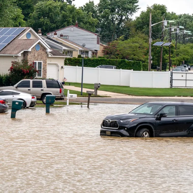 A car is abandoned on a street that remains flooded in the Silver Park West Estates in Edgewater Park, Burlington County. Some homes were also evacuated in the 55-and-older community due to flooding Tuesday night during heavy rains in Burlington County.