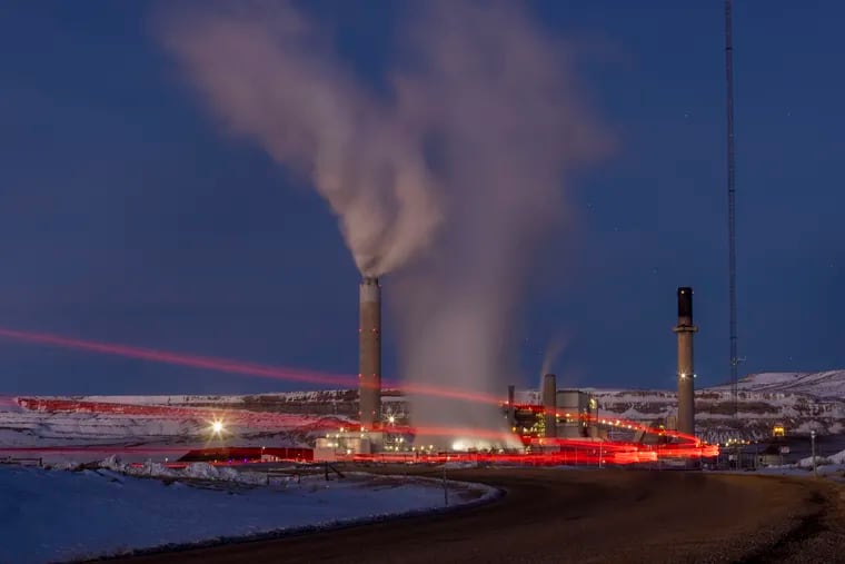 In this photo taken with a slow shutter speed, taillights trace the path of a motor vehicle at the Naughton Power Plant in Kemmerer, Wyo. While the power plant will be closed in 2025, Bill Gates' company TerraPower announced it had chosen Kemmerer for a nontraditional, sodium-cooled nuclear reactor that will bring on workers from a local coal-fired power plant scheduled to close soon.