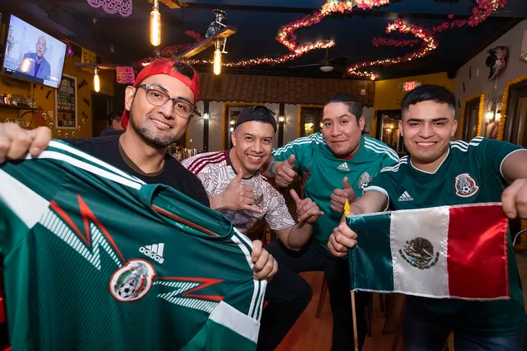 The staff of La Llorona Cantina show off their enthusiasm for Mexico's soccer team. From left are Angel Manzanarez, Marco Ronzon, Pedro Lorenzo, and Javier Onofre.