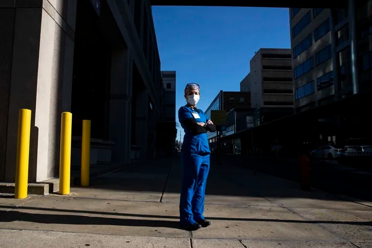 ICU nurse Mary Adamson posed for a portrait on Broad Street outside of the Temple University Hospital in Philadelphia, Pa. on Tuesday, December 15, 2020.